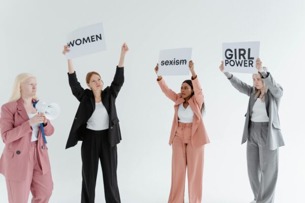 women are holding paper board against something