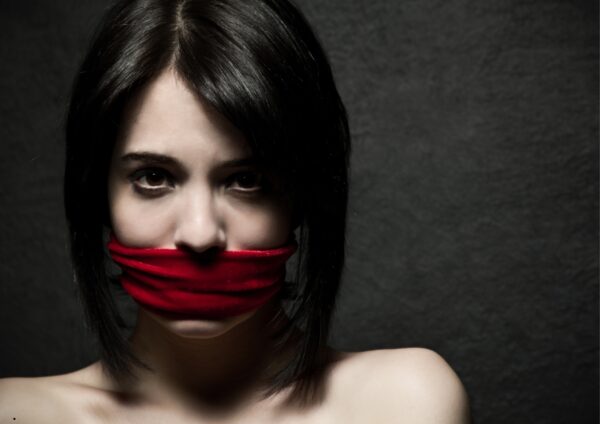 Woman mouth is covered with cloth. that convey the message of silence.