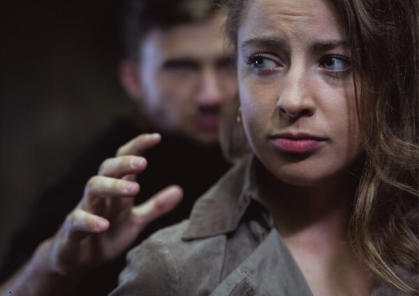 A man is trying to touch the woman