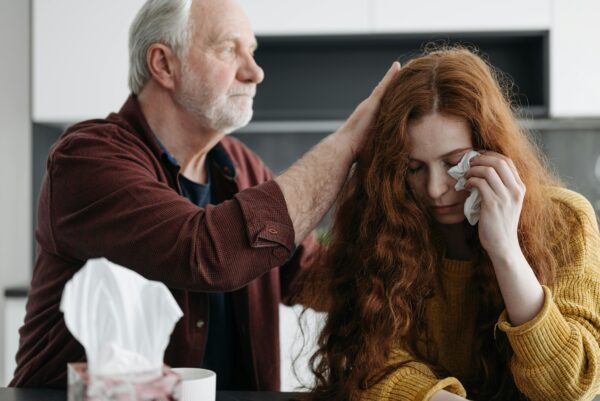 A old man is trying to the girl understand something 