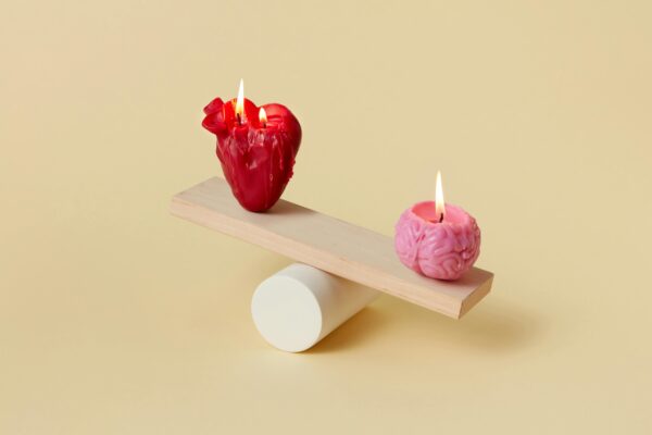 Two heart and brain shaped candles are balancing each other 